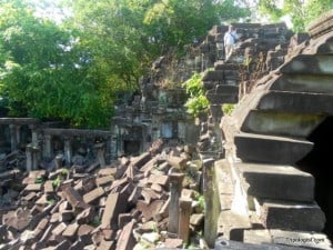 The Tripologist, top right, standing on a rooftop at Beng Mealea Temple.