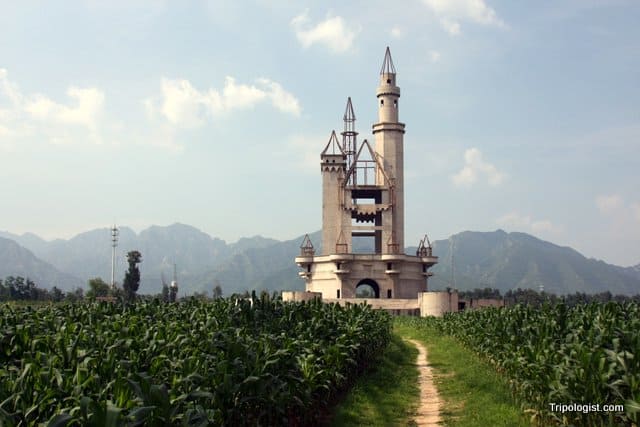 Wonderland Amusement Park's unfinished castle lies amid cornfields and in front of towering mountains outside of Beijing, China.