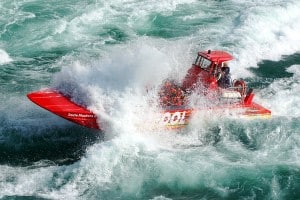 A Whirlpool Jet Boat splashes through class-5 rapids on the Niagara River.