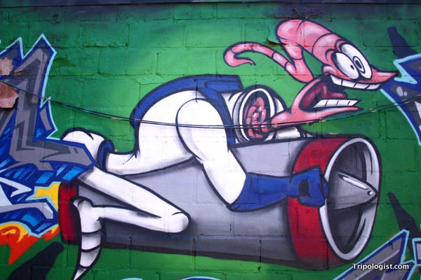 Earthworm Jim riding a rocket through Graffiti Alley in Toronto.